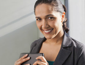 woman smiling with her tablet