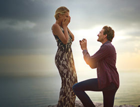 Couple during a proposal at sunset